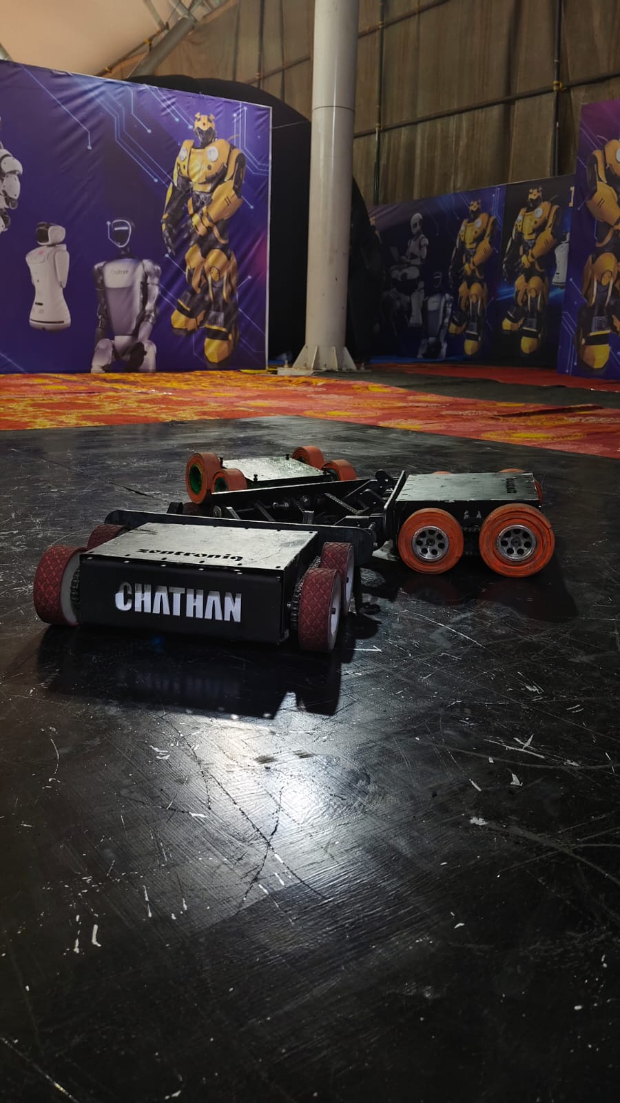 Zentroniq Robo Sumo competition with two combat robots facing off in an arena
